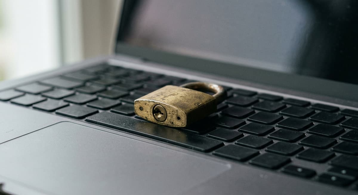 brass padlock resting on a laptop keyboard