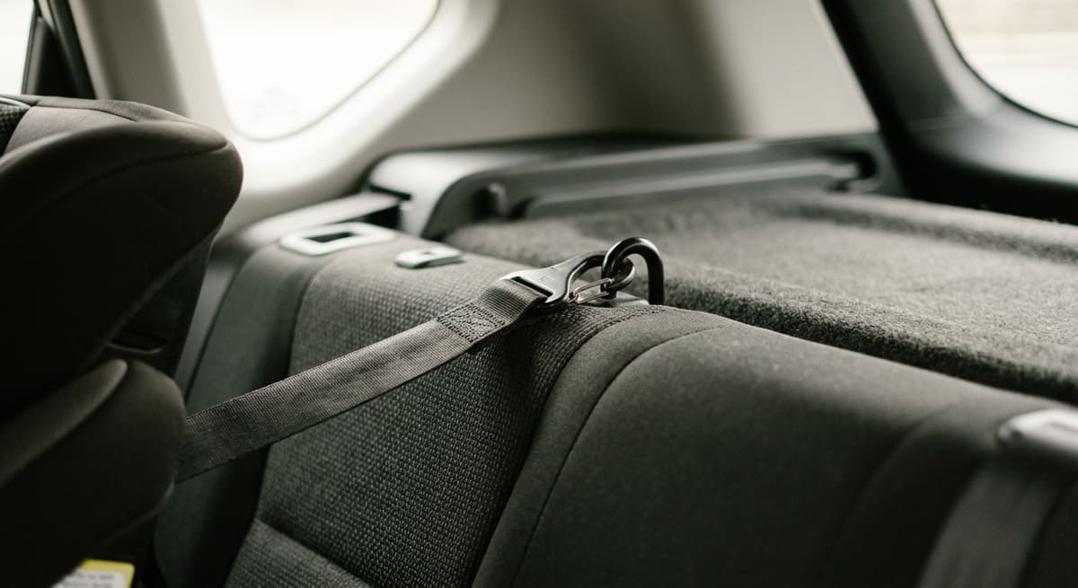A top-tether strap hooked to an anchor point behind the rear seat