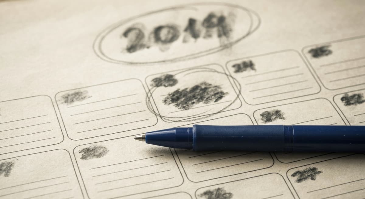 a wall calendar page with a year circled in pencil beside a pen