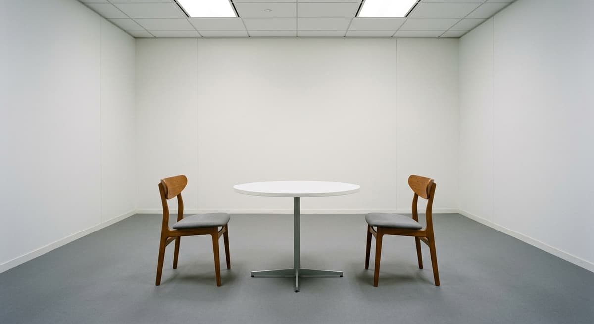 Alabama two chairs across a round table in an office meeting room